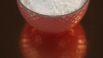 Motion above bowl with wheat flour on shiny mirror surface video