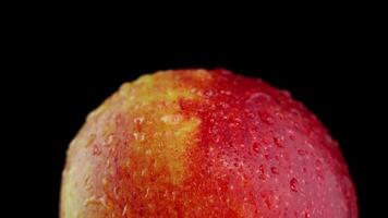 Rotation around the red and yellow apple on a black background video