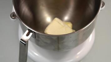 Molt butter in metal container of modern dough maker video