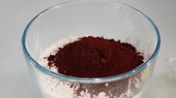 Motion over bowl with flour and cocoa powder on white table video