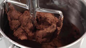 Mixing part of kneading machine covered with raw brown dough video