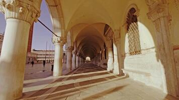 Motion along passage with arches and columns of Doge palace video