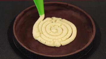 Applying dough into baking dish to make cake on table video