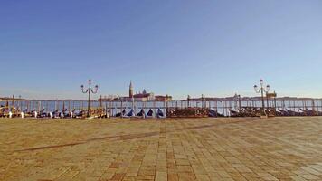 Gondolas moored to waterfront on empty St Marks square video