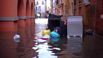 Garbage and plastic trash cans float on water after flood video