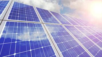 Motion along solar panels with reflected blue sky and clouds video