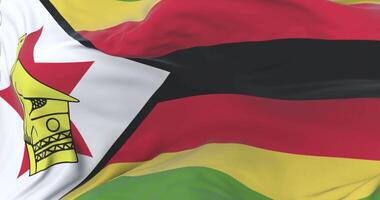 Flag of Zimbabwe waving at wind in slow with blue sky, loop video