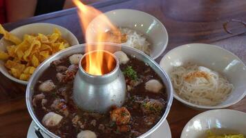 A meatball soup while the beef broth is boiling and steam is gushing out. video