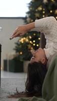 Enjoying a relaxing moment while using my smartphone underneath the beautiful Christmas tree video
