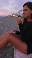Enjoying a Serene Evening at the Beach While Savoring a Delicious Snack With Friends video