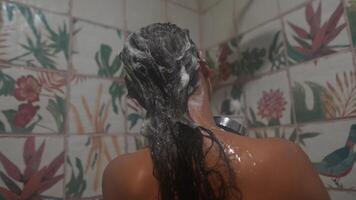 A woman is showering while surrounded by a beautiful and lush background setting video
