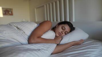Peaceful Sleep A Woman Enjoying a Restful and Comfortable Time while Resting in Bed video