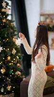 A Joyful and Festive Girl is Decorating for the Holiday Season with a Beautiful Star Ornament video