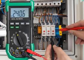 Digital Multimeter Measuring Voltage in Electrical Circuit photo