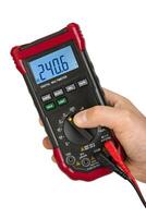 Hand Operating Digital Multimeter Displaying Voltage photo