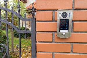 Gate intercom keypad on brick pillar photo