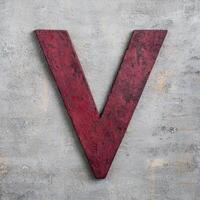 Distressed red letter v on concrete background photo