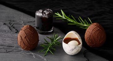 Chocolate Easter eggs with rosemary and cold drink photo