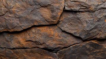 Rugged rock texture with cracks and crevices photo