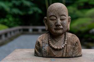 Serene stone buddha statue in lush garden photo