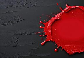 Vibrant red paint splash on dark background photo