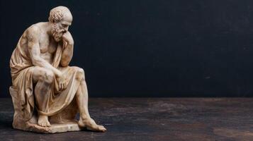 Thoughtful ancient greek philosopher statue photo
