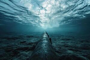 Underwater view of a submerged pipe in the ocean photo