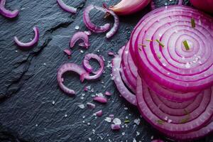 Sliced red onion on dark background photo