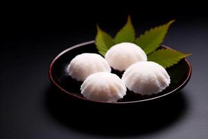 Delicate japanese mochi rice cakes on dark background photo
