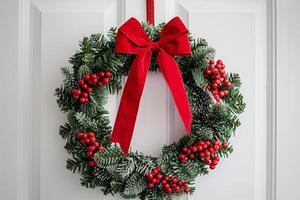 festive christmas wreath with red bow and berries photo