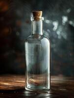 Vintage glass bottle with cork stopper on rustic wooden table photo