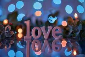 Glowing love message with bokeh lights photo