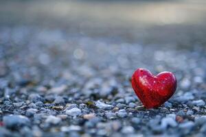 Sparkling red heart on a pebble beach photo