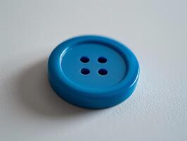 Bright blue button on a neutral background photo