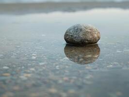 Serene stone reflection in calm waters photo