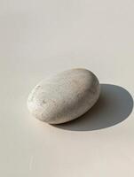 Smooth stone on a plain background photo