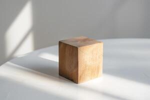 Wooden cube on a white surface photo