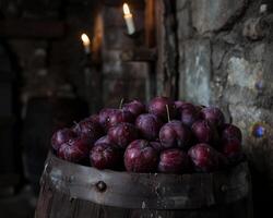Ripe plums in a rustic wooden barrel photo