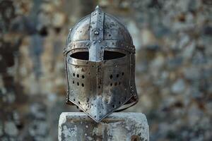 Weathered medieval knights helmet on a stone plinth photo