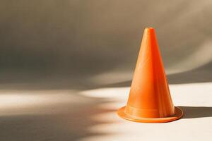 Bright orange traffic cone on a dark background photo