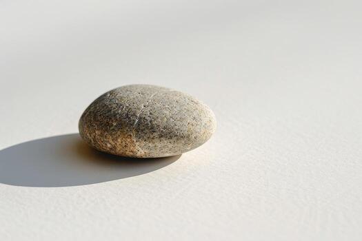 Smooth stone on a minimalist background photo
