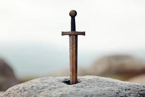 ancient sword embedded in stone photo