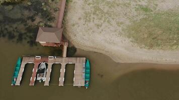 A boat dock at a country fishing lodge on the river. view from the drone copter. video