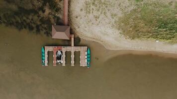 A boat dock at a country fishing lodge on the river. view from the drone copter. video