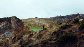 Experience the mesmerizing of Kelimutu's Three Color Lake in Ende. Wrapped in mystical clouds, this magical site, rich in legend, offers a breathtaking landscape that captivates the soul. video