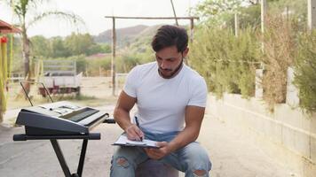 Boy Test Musical Chords On The Keyboard And Marks The Notes In The Score video