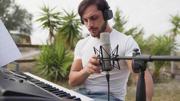 Singer Author Sets Up The Microphone And Sings Playing The Keyboard video