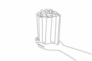 National Popcorn Day. One continuous line drawing of person hand holding stripped paper bucket contain salted popcorn. Food snack to watch a movie concept. Single line draw graphic illustration vector