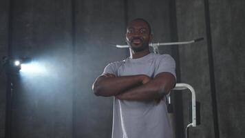 Fitness workout in gym. Portrait of African American man standing in gym with motivation health energy ready for training. Athletic coach personal trainer fitness club owner. Healthy lifestyle video