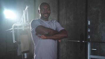 Fitness workout in gym. Portrait of African American man standing in gym with motivation health energy ready for training. Athletic coach personal trainer fitness club owner. Healthy lifestyle video